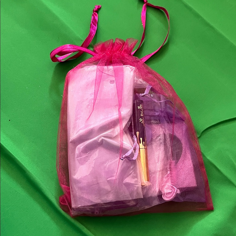 Pink Organza Gift Bag with Assorted Items Lashes Sunglasses and Matte Lipstick